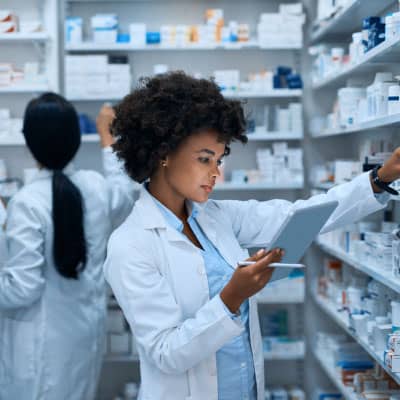 Pharmacist checking medication inventory